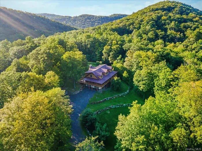 Opportunity Knocks! Nestled on 13.8 acres, this 3, 600 sq ft log home blends cozy cabin vibes with modern touches and needs some TLC to reach its full potential. Inside, you&rsquo;ll find lofty ceilings, open floor plan, hardwood floors, natural light, radiant heating and an impressive fireplace that is the focal point of the main living space. The kitchen is perfect for entertaining and outfitted with a large island while the main floor master suite offers a private retreat.  Flexible spaces throughout the home provide room for a home office, gym, or studio, and the large unfinished walk-out basement invites endless possibilities. Relax on the wrap-around deck and soak in the beauty of your expansive property.  Just an hour from NYC, this home offers year-round activities like skiing, kayaking, and hiking, plus easy access to Warwick and Greenwood Lake Villages&rsquo; eateries and shops. With incredible potential, this property is a blank canvas for your personal touch. **Showings are by appointment ONLY** Do not go unaccompanied.