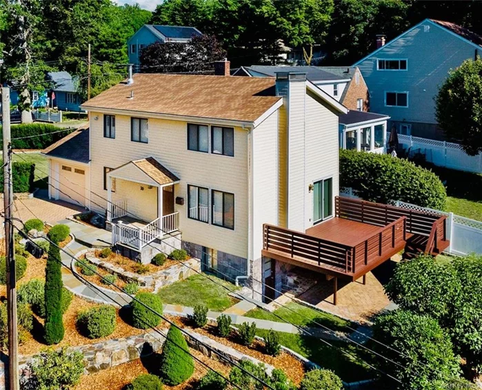 Elevated on an attractively landscaped and versatile corner property in the Village of Dobbs Ferry, this meticulous 4-bedroom, 2.5-bath Colonial has so much to offer. Durable materials such as Hardie Plank siding, bluestone walkways, natural stone retaining walls, Belgian block curbing, and Cambridge Pavers on driveway add to the permanence and appeal of the home. Standing on the front patio, the view over the neighboring properties and expansive southern sky is exhilarating. The home&rsquo;s open-concept main level sparkles with polished oak floors, flooded with light from three exposures. A wood-burning fireplace with natural stone surround enhances the living area, and large glass sliders lead to a delightful deck for entertaining among treetop views. Enjoy a designer kitchen with granite counters, stainless appliances, convection oven, and peninsula overlooking the adjacent dining area. Upstairs, all three bedrooms have lustrous oak floors and ample closets that include customized closet systems, lighting, and sliding doors with frosted glass panes. A large western-facing window illuminates the spacious and glistening hall bath, featuring dual sinks and built-in hamper/storage. The home&rsquo;s 4th bedroom and 2nd bath are located on a walk-out lower level(an estimated additional 615 sf), where you will also find a large recreation room with convenient door to the yard. In addition, a well-organized and pristine attached garage provides upgraded 200V electrical service, an EV charging outlet, and plenty of customized storage areas. Other bonus amenities of the home include custom stained-glass panels at front door and select kitchen cabinets, Hunter Douglas motorized shades on windows, central AC, 4-zone sprinkler system, two separate attic spaces for storage, and low voltage exterior lighting. Outdoor enjoyment is enriched by a variety of flower beds, two rock gardens, and a grassy, level side yard bordered by evergreen trees for visual privacy. A few blocks away, wander through the verdant Juhring Nature Preserve or head over to Gould Park for a ballgame or swim. The Village offers award-winning public schools, a vibrant downtown, and a 40-minute train commute to GCT. This mint-condition home is move-in ready and waiting to be treasured.