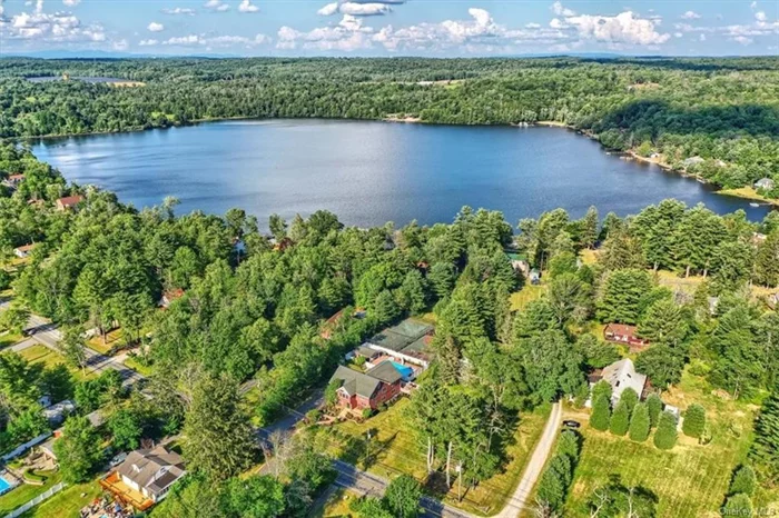 First time on the market!   Introducing 517 Sackett Lake Road, a custom-built house on 2.17 acres with access to a private sandy beach on sparkling Sackett Lake.    Highlights:  - 11 spacious bedrooms  - 12.5 bathrooms (plus two additional in the pool house)  - 2.17 acres  - Over 6, 000sf  - Central Air  - Full, finished basement with a movie theater and game room  - Large garage can fit two vehicles plus boats and lake toys  - Large front and back deck with a screened-in porch  - Beautiful in-ground pool with a hot tub and kiddie pool  - Pool house with changing rooms, showers, refrigerator, and laundry  - Full basketball court  - Tennis court  - Playground  - Access to a sandy beach.  The massive house offers 11 bedrooms, and 12.5 bathrooms split between three floors. The first floor features a large eat-in kitchen, a formal dining room, separate living room and three bedrooms. The 2nd floor offers six bedrooms, an office, and a family room with a kitchenette. The top floor offers two additional bedrooms, and a family room with a kitchenette. The basement has a movie theater, game room, storage, and a large garage.   Out back is the gated in-ground pool area which features a pool house with changing rooms, two bathrooms, and laundry. There is a large in-ground pool with a diving board, a hot tub and a kiddie pool. There is also a built-in BBQ grill station.   There is a full-size tennis court and basketball court as well as a large playground.   With 2.17 acres of land, there is plenty of space to play, expand or sub-divide.  There is direct access to a private sandy beach on Sackett Lake which is a private, 124+ acre motorboat lake with no dues or HOA restrictions. There is great fishing, swimming, and boating, and in the winter, ice-fishing & ice skating.