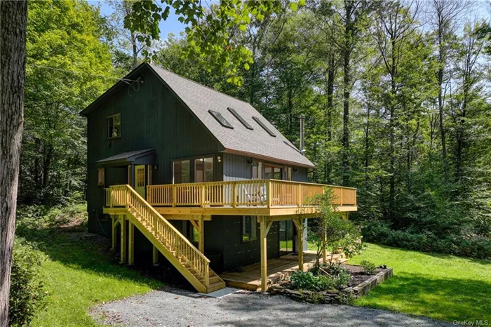 Tucked away on 3.8 private and idyllic acres, this Cape Cod-style home charms. Built in 1988, it has an ideal combination of space, light, and outdoor activities. With 3 inviting bedrooms and 2 full bathrooms, this home is designed for both comfortable living and easy entertaining.  At the core of the home, high ceilings great an airy sense of volume, the skylights ushering in light even in the winter months. A wood stove sits idly in the corner with a nicely bluestone-faced hearth, fire this up in a couple months to keep away winter chills.   The kitchen has ample cabinetry and is a nicely organized U-shape for getting your chef on. Keep the dining table where it is or bring a larger one out to the main area for dinner entertaining. The stove and fridge were recently replaced.  Three nicely sized bedrooms are accompanied by two full bathrooms. The first of each is on the main floor. The upstairs has the remaining two beds and second full bath.   The large deck, replaced in July &rsquo;24, is a glorious way to spend a summer, spring or fall day. South-facing, it gets great sunlight for planters and loungers. Feeling too warm for you? There is a shaded deck just below which can be accessed by the sliding doors on the lower level.  Downstairs is an ideal den or media room or office. Half the lower level is nicely finished, the other half has a workshop area, the mechanicals, washer/dryer, and loads of storage.  The home is part of a welcoming HOA. There is a short trail that leads to an Olympic-sized pool, two tennis courts, and a fishing pond, providing a variety of outdoor activities just steps from your door.