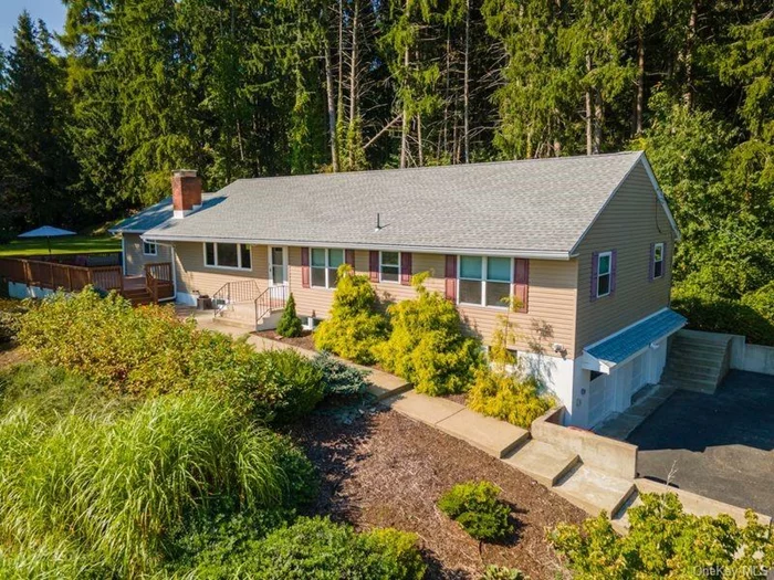 Welcome to this beautiful four bedroom, three bathroom ranch style home positioned at the end of a Cul-de-Sac. The main level features: A picture window that allows the natural light to flow through the open floor plan. The Living room highlights a two sided corner - wood burning fireplace and connects with the dining room - both rooms have NEW refinished hardwood floors. The walk through kitchen highlights a NEW stainless steel refrigerator and New Stainless steel stove plus an entrance to the rear property. The beautiful large family room is also filled with natural light and highlights 18ft Vaulted ceiling along with recessed lighting, built-in cabinetry, a ceiling fan plus access to a SUPER LARGE wrap-around L-Shaped deck overlooking the expansive property - What a fabulous area to entertain and enjoy with family and friends along with complete privacy. The remodeled bedroom and bathroom suite highlight a walk in closet. Two additional bedrooms and a second remodeled hallway bathroom make up the main floor of one level living. The recently remodeled lower level features: A spacious custom designed laundry room with built-in cabinetry, quartz countertops, a sink and a front loader washer & dryer. There is an Office/Den, a LARGE family room and a room for a gym or play area. The beautiful designed bathroom has an oversize walk in shower. There is a storage room and a Utility room plus an entrance to a two car garage - The home has Municipal Water & Sewer, 3 Zone Heating, All three bedrooms highlight NEW custom baseboard moldings, NEW split A/C units in 2022, NEW Roof with warranty & NEW garage door openers in August 2024. The front of the property features an underground sprinkler system. This home has amazing potential for a Mother/Daughter arrangement and is located close to Shopping, Restaurants, Metro North trains, Rt-9, Rt-84 and the Taconic State Parkway