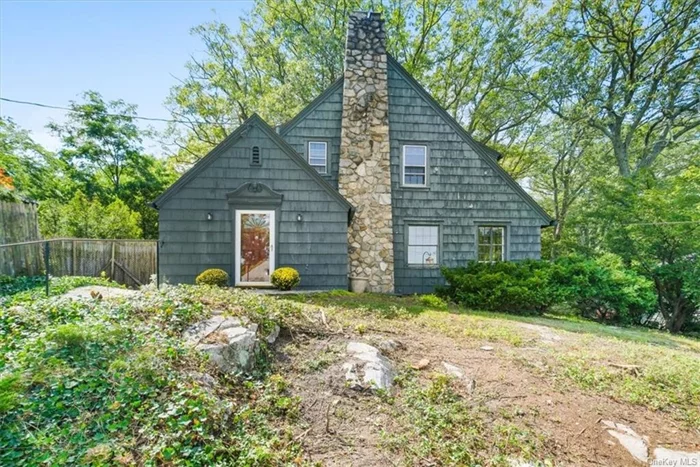 Nestled on a scenic hilltop sits this 1930&rsquo;s spacious 3-bedroom colonial filled with old-world charm. Enter the front vestibule that includes a powder room and coat closet. Enjoy many cozy evenings in front of your woodburning stone fireplace or settle in with a good book in your family room surrounded by nature. Formal dining room leads to eat-in-kitchen which features an office nook and door to side patio. Second level features primary bedroom with built in dresser, desk and walk-in closet, two other bedrooms, and two full bathrooms complete this floor. Full unfinished basement features a one car garage/work/craft room, laundry, mechanicals. Taxes are without Star Rebate of $2, 050 if qualified. While the home requires updating it is truly a rare find and a great opportunity to add your personal touches and make this home your forever home. All this within a short driving distance to Depew Park, Metro North (1.3 miles), Peekskill&rsquo;s vibrant Riverfront Green Park, Water Front Trail, Boat Launch, Peekskill Yacht Club, Restaurants, Brewery, downtown Peekskill Art Galleries, Theater, Stores, Restaurants and Coffee Shops.