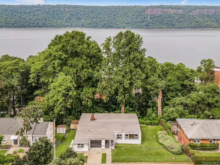 Welcome to this beautifully renovated ranch-style home, perched above the Hudson River in the desirable Woodstock Park area. This spacious 53-ft wide home has been meticulously updated from top to bottom, offering modern comfort and classic charm. Entryway: As you enter through the new storm door, you&rsquo;ll be greeted by a bright and welcoming windowed entry hall featuring stone tile flooring and a stylish new front door. This space provides ample room for your interior design ideas. Living Area: The expansive living room showcases refinished hardwood floors and a striking floor-to-ceiling wood-burning brick fireplace. A wall of windows along the living room offers breathtaking views of the Hudson River, while an enclosed, windowed porch stretches the entire width of the space. Dining Room & Kitchen: The formal dining room is perfectly positioned on the opposite side of the fireplace, leading into the newly renovated kitchen. The kitchen boasts ample counter space, stainless-steel appliances, and elegant quartz countertops. A convenient hall of closets in the kitchen area includes a pantry, linen closet, and guest coat closet. Mud/Laundry Room/Office: The spacious mud and laundry room features a second fridge, possible office area and additional access to the front of the house, making it ideal for busy families. Master Suite: The master bedroom offers a newly renovated full bath with a walk-in shower and his-and-her closets, ensuring plenty of storage space. Two additional family-sized bedrooms are adjacent to a hall bath, providing ample room for family and guests. Lower Level: The finished lower level includes a versatile storage room, a potential gym area, and a cozy family room. A wall of windows overlooks a 750 sf all-season room, featuring a new porcelain tile floor, a second FPL and doors leading to the yard. A new 2-ton ductless AC/heating unit ensures comfort throughout the year. Additional Features: Freshly painted interior and exterior Upgraded 200 AMP electric service New storm door, front door, garage door, and motor New light fixtures and updated electrical outlets throughout This home has undergone extensive upgrades, making it a true gem in Woodstock Park. Don&rsquo;t miss your chance to experience the serene river views and comfortable living this property offers. All this and on a double lot, 100 x100 property. Aqueduct trail behind house.