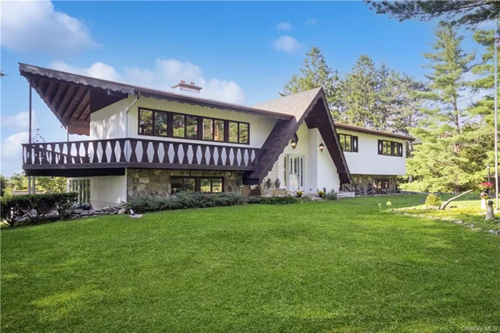 Welcome to this lovely residence, first time on the market. This expansive home was lovingly custom built, overlooking 6.22 wooded acres providing privacy, with views westward through plentiful windows to the Hudson Highlands and on to the Catskills. From the wide foyer, up a few steps to the main floor. To your left a generously sized dining room has a large stone fireplace. The walk though kitchen opens to a music room, with direct access to covered deck. From the hallway you find the laundry, primary suite, and 2nd and 3rd bedrooms, and hall bath. The lower level features water statuary, flanking a wet bar and family room, also with fireplace. Generous storage follows the wall behind. A 4th bedroom plus office/study on one side, and sunny conservatory opens onto wrap around patio complete with hammock hookup. The large, private backyard has raised garden beds, large storage shed and a whimsical hobbit house feature. Truly a an elegant oasis in which to write your own story.