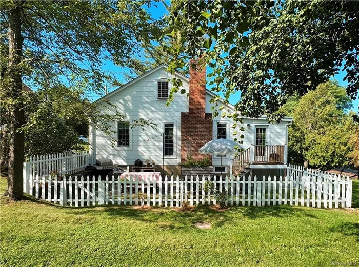 Welcome home to this picturesque cottage in the idyllic Hudson Valley town of Cornwall.  Located just a stone&rsquo;s throw to the Hudson Highlands Nature Preserve, shops and dining on Main Street Cornwall, this impeccably maintained property dotted with flowering trees offers a stunning view of Storm King Mountain. Situated conveniently off RT 9W, approx 56 miles to Midtown, or 5 miles to NJT train to Penn Station makes the home an accessible retreat from the city.  The home has a cedar shingled carport, single car garage, and blue stone retaining wall, walkway and steps lead up to 2 front porch entrances. Enter this charming 2 bedroom, 1 bath cottage into a large sunroom with beadboard ceiling and 2 large closets (second front entry point makes it possible to convert sunroom into an additional bedroom if desired). The open floor plan kitchen, dining area, and living room are centered around a stone fireplace, flanked by two floor to ceiling windows, and the recently painted white walls, raw oak floor, and well-positioned Energy Star Anderson windows, make the heart of the home feel light and airy throughout the day.  The newly updated kitchen features Carrara Marble counter tops, Cl Tile handmade Moroccan backsplash, Waterworks brass faucet new stainless steel refrigerator and recently installed Viking appliances: range, dishwasher, and convection microwave. The dining area has built-in bench seating which doubles as storage. The bathroom has been recently updated with Kota Blue Limestone flooring, classic subway tile, and new Kohler and Duravit fixtures. Both bedrooms face the back of the property, which abuts acreage that is part of a land trust and thus protected from future development.  The primary bedroom fits a queen bed and secondary bedroom also could work as either office or guest room. An additional walk-up attic provides approx 500 sq ft of storage. Large basement/ garage below the home contains washer and dryer and offers ample storage. Home has central heating and air, along with a Generac Back-up Generator for peace of mind. Walk out onto the back porch and you are transported to most magical part of the property: a white picket fenced-in patio, bordered by lilacs and roses, and complete with blue stone pavers, which create the perfect spot for relaxing, grilling, entertaining friends, and enjoying the views from your little slice of heaven. Design details and high-end fixtures and lighting throughout the home, plus close proximity to hiking trails, Cornwall town center, Storm King Sculpture Park, Westpoint, Jones Farm all within range of NYC make this delightful Cornwall cottage a must-see.