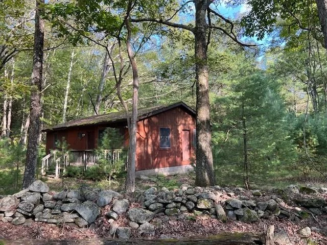 Tucked away up a meandering rustic driveway is this sweet country cottage. Surrounded by stone walls, hemlock and pine trees, maple and oak with fiddlehead ferns this setting is the place where dreams are made. Looking for a great location to hang a hammock and relax while glamping or get back to the basics in this cozy home offers shelter without any frills. Electric and telephone connected but other conveniences have not been installed yet so use it as is or get permit for well, septic, plumbing and make this current seasonal cabin into a year round getaway. Privacy and seclusion prevail with a beautiful stream on your own property across the street. Close to Port Jervis for commuter trains, farmers markets, coffee shops, hiking trails, schools and shopping. Great Location only 2 Hours NYC.