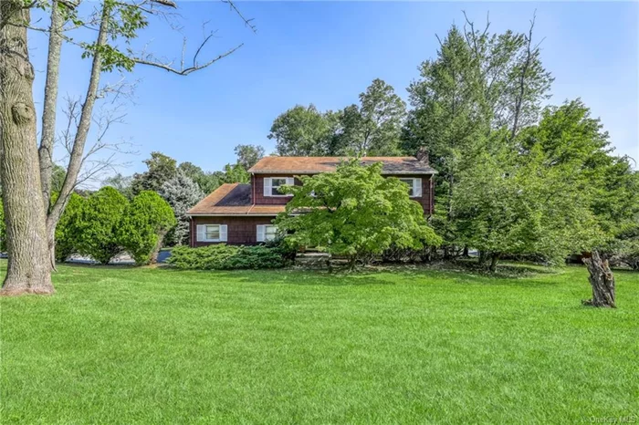 Nestled on a spacious corner lot, this charming 4-bedroom, 2.5-bath Colonial awaits a little TLC to become the dream home you&rsquo;ve been looking for. The welcoming foyer opens to a bright living room with recessed lighting, hardwood floors, and a striking white brick wall featuring a wood-burning fireplace. A sunny formal dining room leads into the eat-in kitchen, complete with a peninsula and walk-out to a large deck perfect for outdoor entertaining. The cozy great room offers a second fireplace, another deck access, and a convenient nearby powder room. With a first-floor laundry and mud area, this home provides both charm and practicality. Upstairs features four spacious bedrooms, including a primary suite with a private bath and stall shower. The main bathroom offers a double vanity, perfect for a busy household. A full unfinished basement with sliding door access to the backyard provides endless possibilities for customization. With its classic design, large deck, and expansive corner lot, this home offers a fantastic opportunity to create your perfect space.