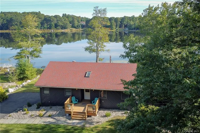 Welcome to this stylish lakefront home with 3 bedrooms and 3 full bathrooms in the Sullivan County Catskills. The center of the home is the spacious living room with vaulted ceilings, freshly refinished wood floors and an incredible view of Treasure Lake from two pairs of sliders that lead out to the deck. Ceiling fans and a breeze off the lake keeps you cool in the summer and, with a propane stove in the living room, you&rsquo;ll be toasty warm on winter nights. Adjacent to the living room is the kitchen with a third set of doors plus a large bay window also overlooking the water. All 3 bedrooms and 2 of the bathrooms are on this floor. Downstairs you&rsquo;ll be wowed by the additional living space which is configured with a big comfy couch, ping pong table and beautifully built custom bar. This is the spot to be for gatherings with friends and family with so much space and easy access to the lake from doors leading out to a new stone patio featuring a grand lakeside fire pit and your own private dock. There is a third bathroom and access to a one car garage on this floor. The sellers have made so many recent updates to the home including new flooring and fresh paint through most of the house, new kitchen appliances, new light fixtures and more. This home is being offered with an option to purchase all furniture (less a few exceptions) making this a truly turnkey opportunity. Part of the Emerald Green community with three beautiful lakes, new swimming pools and a state-of-the-art community space/gym; there are plenty of activities to enjoy with access to playgrounds, tennis and pickle ball courts, a beach and more. Convenient to highways and a short drive to Bethel Woods Center for the Arts and the Kartrite Indoor Water Park plus just under 90 minutes to NYC!