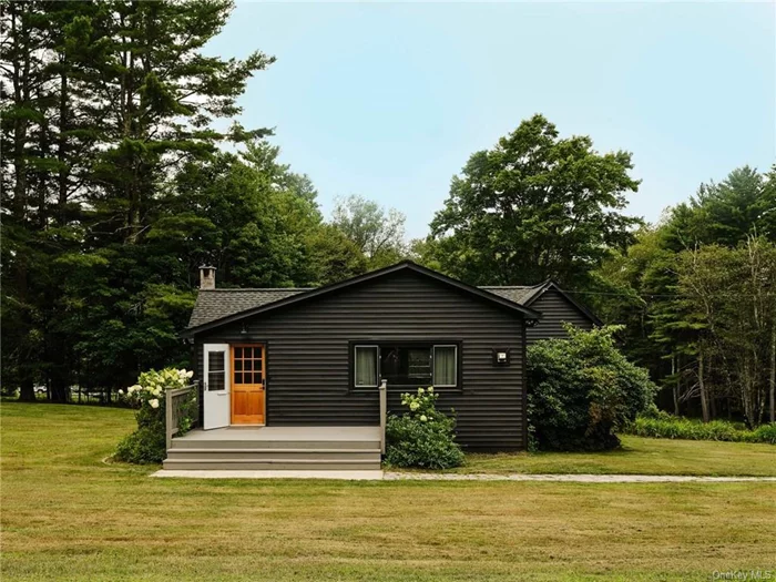 Amid the verdant expanse of the Western Catskills, near the Delaware River, lies the serene haven of Casa Cochecton. Just two hours from the GWB in NYC, this enchanting retreat promises a harmonious blend of natural beauty and thoughtful design, inviting you to escape the clamor of city life and unwind in rural bliss.   Entering through a generous mudroom you are at once welcomed to the country. Step into the sprawling living room with vaulted ceilings, where light cascades through expansive windows, filling the space with a serene, welcoming glow. A formal dining area adorned with a striking midcentury chandelier is just beyond and serves as a central gathering area for the home. Off the dining area, the country kitchen is a testament to timeless charm, featuring classic shaker cabinets, subway-tiled walls, and a bead board ceiling. An apron front sink and a generous walk-in pantry closet offer both practicality and elegance, making this kitchen a delightful space in which to create.  Two tranquil bedrooms, designed to foster rest and relaxation, are also accessed from this central space, one with ensuite bath. The meticulously renovated bathrooms offer modern comforts while retaining the home&rsquo;s rustic charm. Each space is crafted to soothe and rejuvenate, blending style with serenity. The second full bath sits adjacent to the kitchen and is overflowing with charm from the hand painted hardwood floors to the handmade tile and brass fixtures. Beyond the kitchen, the sunroom lounge that transforms into a cozy sleeping area at night, is perfect for morning coffee or an evening aperitif, encouraging you to unwind while gazing out over the expansive yard and surrounding forests. This massive bonus space enchants with warm wood paneling and endless windows and presents boundless opportunities for future uses - a new primary suite, gracious guest space, inspiring work from home office or art studio perhaps? Here, nature&rsquo;s visitors frequently grace your view, enhancing the sense of peace and connection to the land. Outside, an expansive back deck beckons for outdoor dining, entertaining, or simply soaking in the tranquil ambiance. Whether enjoying your morning tea or a starlit evening, this space deepens your connection to nature&rsquo;s beauty.  Conveniently located within minutes of charming towns like Bethel, Narrowsburg and Callicoon, this home provides easy access to a variety of restaurants, shops, breweries and distilleries. Explore the historic Bethel Woods, site of the legendary 1969 Woodstock Festival, or indulge in the myriad outdoor activities the Western Catskills and nearby Poconos offer. Casa Cochecton embodies the wabi-sabi philosophy, inviting you to forsake the artificial pursuit of perfection and embrace the authentic beauty of imperfection. It is a place to truly unwind, surrounded by the natural elegance of the Western Catskills. With a highly successful history as a vacation rental property, Casa Cochecton is an ideal getaway that offers excellent income potential that can substantially offset any carrying costs. Some furnishings available for purchase.