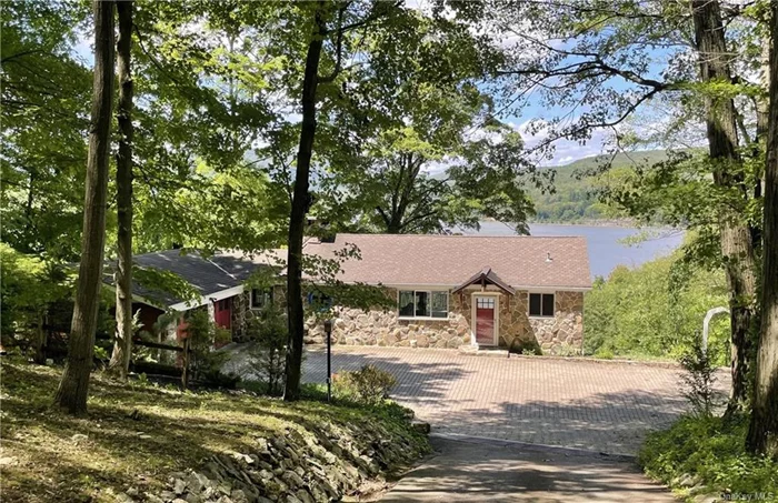 A UNIQUE opportunity awaits to reside in a home graced by Unobstructed Hudson River Views. Encompassing 2.65 acres, newly renovated tiered gardens and stone trails meander almost to the River&rsquo;s edge. Recently renovated, the house, characterized by timber framing, expansive windows, and extended decking offers a natural ambiance and unparalleled views of the Hudson. The generously sized family room showcases a floor-to-ceiling fireplace enveloped in natural stone. This home, perfect as a weekend retreat or full-time residence, features 2 en suite bedrooms on separate floors with separate entrances plus an extra full bath on each floor ideal for visitors or extended family. Experience the epitome of comfort and luxury against the backdrop of the mighty Hudson River! Included in this offering is a .5-acre parcel on the Main Road (Route 9D), strategically zoned Commercial. Efficiency is prioritized with a new state-of-the-art energy-efficient electric boiler complemented by a heat pump with mini-splits for optimal heating and cooling. Proximity to hiking trails, golf courses, marinas, restaurants, and the picturesque town of Cold Spring enhances the lifestyle appeal. A quick commute to Metro North, just 50 miles to Manhattan, and low taxes add to the property&rsquo;s allure.