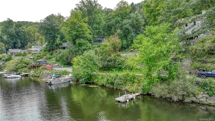 With Lake Zoar and Steel Bridge views and access through your own private dock, there is a beautiful 2 bedroom (lives like 3), 1 bath 1, 613 sqft Ranch/Cottage on parklike 1.50 acres with a hot tub. As you enter, you are greeted by a cute foyer where you can hang your coat & put on your shoes. From there you head into your Eat in country kitchen. With a rustic, yet modern function it has tons of cabinets, Washer & dryer Appliances and dining area. From there, you can relax in the huge formal living room with a stone fireplace, rustic wood beam ceilings. Through there you have a full bath and standalone raind shower with steam and aromatherapy. Adjacent is the Primary bedroom that has incredible views of the water. Also, it has a spiral staircase, heading downstairs. 2nd bedroom is smaller with a balcony. Downstairs has so much to offer. With a walkout off the family room, it comes complete with a huge space, private office that can also be used as a guest bedroom with closet and tons of unfinished storage area where utilities are. Huge private parking by the house, car port and 3 car parking access for the dock. Seller has installed a full retaining wall under the fence. Taxes do not reflect exemptions