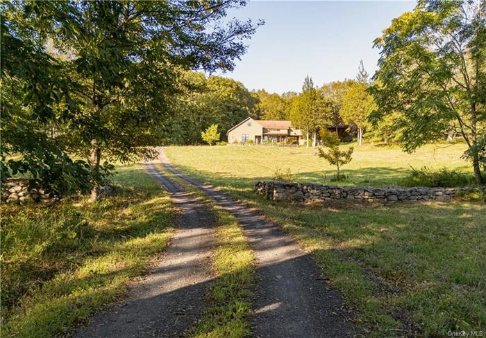 A/O Oct 2. Show for back-ups. The Meadow House gently rises, a unifying element between the open fields and the hidden forest. Approached by a long meandering driveway off a country road, along and through laid stone walls, past majestic pin oaks, this singular home was custom designed to capture the ever-changing light as well as manage the ambient temperature. Meadow House is an interplay between gentle curves and angular lines, soaring ceilings and intimate niches, vast window walls and warm woods. Central to this 3700+sqft home is the Chef&rsquo;s Kitchen w/ soapstone counters, a central island, walnut cabinetry and the 8-burner Wolf range. The Dining Room, w/soaring beamed ceilings, opens onto a most special bluestone patio created by Nepalese artisans. Up a few steps and between two massive Douglas Fir timber posts, we enter the Living Room with an inviting stone woodburning fireplace and a wall of deep bookcases. The built-in leather-cushioned banquette spans 2 walls and provides the viewing spot for nature&rsquo;s unfolding beauty, the hearth, as well as media. This home is atypical and thus rooms offer several distinct usages as desired. We have 3 (or 4 or more ) bedrooms; the main floor ensuite primary has a sunrise sitting area which opens out to the cedar grove. An interior bridge (and exterior breezeway) connects the main house with Guest Quarters, aka Studios/Gym/Offices. This sundrenched space, with a full bath and exterior accesses, enable the many ways your needs and wishes will unfold here. The meadows offer grazing for horses, sheep and goats and the fenced, the raised-bed vegetable garden abundantly produces for your own farm-to-table. The large 2-room shed is ripe for transformation into further creative space and the walk through the woods along old walls leads you to the Kripplebush Creek. With private forest bathing, big-sky bird watching and star gazing, this property offers you permission to retreat into nature and yourself. The residence as well as the 40+ acres of land will awaken your long-hidden self. Minutes into the charming villages of Stone Ridge and High Falls, Mohonk Mountain House, Minnewaska Trails, Inness and so much more, this offering is a very fine balance.