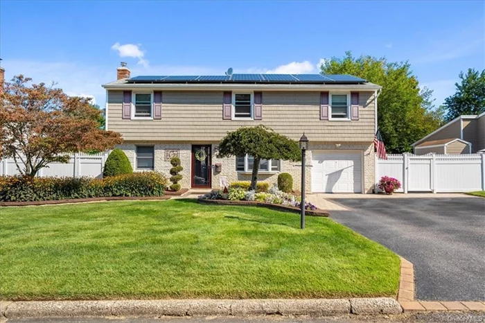 This stunning split-level home offers the perfect blend of comfort and style, nestled on a beautifully landscaped lot with brand new pavers. Step inside to an airy, open layout featuring gleaming hardwood floors throughout. Enjoy two spacious living rooms and a dining area ideal for gatherings. The first level includes a convenient primary suite, perfect for privacy. Upstairs, you&rsquo;ll find four additional bedrooms, including a second primary suite with a large walk-in closet and en-suite bathroom. Outside, the backyard is an entertainer&rsquo;s dream, complete with a Trex deck, pavers, and ample space for outdoor fun.