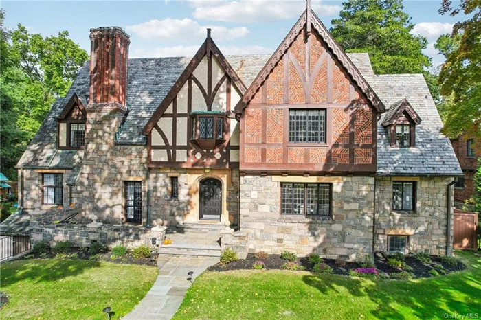 A breathtaking Tudor style residence, nestled on a grand corner lot in one of New Rochelle&rsquo;s most distinguished and desirable neighborhoods, can be your next dream home. Highlighting it&rsquo;s original architectural design of elegant masonry and stonework, leaded glass windows, and four-centred archways, this monumental 6 bedroom home features an exceptional layout with grand rooms and functional spaces ideal for your day to day living and entertaining. The first floor presents a majestic living room with fireplace, a recently updated kitchen, formal dining room, den, and a bedroom with en-suite bath ideal for guests. The second floor features 5 large bedrooms, where the glorious primary suite boasts a beautiful fireplace and en-suite bath. The massive walk up attic provides additional space for your imagination, as well as 700 sq ft of bonus space in the basement. The lush greens in the expansive yard create spectacular vibes to enjoy the notable rear patio and yard all year round.