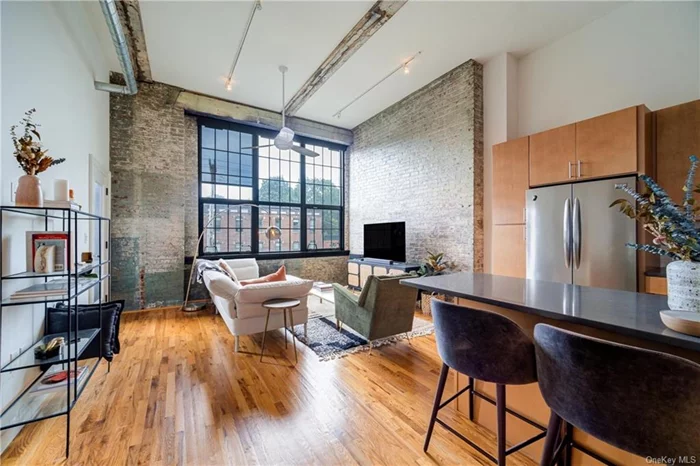 One of the most unique and historic condominium buildings in Beacon! Formerly the Electric Blanket factory in the 30&rsquo;s, this brick and steel building has kept its original details and upgraded into modern design. Spectacular views and amazing natural light come in from the 10 x 10 windows. Beautiful time period features throughout including 13 foot ceilings, original beams and steel fixtures, and exposed brick walls. Kitchen has lots of cabinetry with stainless appliances and prep island with seating opening up to living room. Spacious Primary bedroom with abundant closet space. Enjoy your summer and fall evenings on your private covered balcony. Prime walkable location in Beacon near shops and restaurants. Minutes to trains and metro north line. All the modern conveniences are here, including current installation of charging ports for electronic vehicles. This gorgeous unit is stunning and a must see!