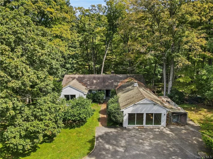 Bring your vision and ideas to this delightful home, built in 1955 and situated on 16.8 sprawling acres and zoned for 2 horses. The 2, 829 square foot home features an Eat-in-Kitchen with gas stove, double wall oven, refrigerator/freezer, and dishwasher. The Dining Room has tile flooring and two adorable built-ins, while the light-filled Living Room offers a stone fireplace. A spacious Play/Sun Room has two large sliders that open to the front of house. The three bedrooms provide ample space, along with the expanded Primary bedroom with slider and full bath. Hardwood flooring lies beneath the carpeting in most areas of the home. Utilities include a Kohler generator with a separate propane tank, two horizontal oil tanks and a hot water heater. There is a attic fan that cools the whole house A detached three-car garage for vehicles, storage, or a workshop. There is a pony shed which is in need of renovation. The property invites outdoor activities, gardening and relaxing on the deck surrounded by nature. A brook runs along the front of the property which feeds into the Titicus Reservoir. County owned land is across the street, and nearby Mountain Lakes Park offers hiking, canoeing, kayaking, and a summer camp.  Close to I684, I84 , shopping, restaurants and nearby train stations (Goldens Bridge, Purdy&rsquo;s , Croton Falls) .