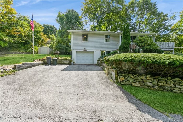 Classic raised ranch home featuring 3 bedrooms 1.5 baths and full walk out basement. This home offers an expansive deck that overlooks a large level yard. Great home for family gatherings and entertaining. This home is in the picturesque Lake Carmel District that includes lake rights along with beaches, playground, bike baths and walking paths. Easy commuter location! Close to public transport, highways and shopping. Total square footage of 960 square ft does not include the finished lower level which is an additional 448 square ft.