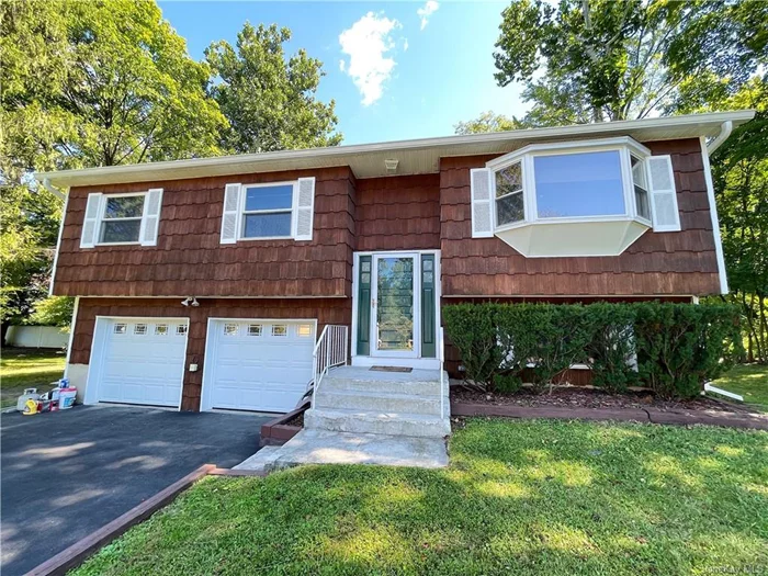 Welcome to your new home in the Spackenkill school district! This raised ranch offers the perfect blend of comfort and functionality. The main level features hardwood flooring throughout. The large, inviting living area is ideal for both relaxing and entertaining. Featuring 3 spacious bedrooms and 2 full bathrooms one on each floor this home ensures convenience and privacy for all. Step outside to discover the massive deck in the backyard, perfect for hosting get-togethers or simply enjoying a quiet evening. The property also includes a shed for extra storage and an attached 2-car garage for added convenience.