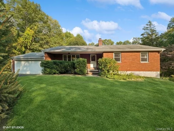 Well appointed and light-filled brick ranch home on almost an acre of park-like property. Welcoming front porch leads to this three bedroom and two bath home. Expansive living room with plenty of room for entertaining, leads to diningroom and updated eat-in kitchen with newer stainless appliances, glass tile backsplash, an abundance of cabinets for storage, and plenty of counter space for prep. Newer full bathroom with soaking tub, and tile shower with glass doors. The large primary bedroom, with walk-in closet, has gorgeous views of the backyard. Two additional bedrooms with lots of light. This home boasts gleaming hardwood floors throughout, new windows, new boiler, two car garage, storage shed and an 18x24 square foot storage room on lower level. Lower level offers a den / recreation room with handsome brick fireplace and pellet stove insert, perfect for cool nights. Separate laundry area, bathroom with shower, and direct access to yard - perfect for guests! Peaceful backyard perfect for relaxing, bird watching, with plenty of space for a pool and garden. Gorgeous lilac, Japanese Maples, rhododendrons and Rose of Sharon surround the property. Minutes to Route 84 and the Taconic State Parkway. Close to shops, restaurants and hiking. Beautiful home!