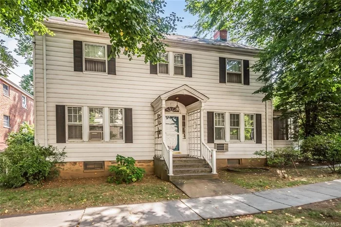 Discover the perfect blend of classic charm and convenience in this delightful 4-bedroom, 1.5-bath center-hall colonial home nestled on a corner property in this NYC prime location of Woodlawn. This well-maintained home welcomes you with an inviting entry foyer greeted by a rich wood bannister that sets the tone for the home&rsquo;s refined aesthetic. It boasts a spacious living room with a wood-burning fireplace plus double French doors to a bright enclosed sunroom. This sunlit home features a cozy eat-in-kitchen which flows lovingly into the formal dining room with original built-in china closets. The interior showcases intricate moldings, hardwood floors, and traditional details that reflect the craftsmanship of this quaint home. The second floor is complete with four generously-sized bedrooms along with a full bathroom. The walk-up attic completely insulated has so much space for storage and has endless possibilities to add additional living space. The unfinished basement level has plenty of storage, which features the utility room, laundry and enough room to create your own area for a home gym, office or play area. Situated on a lovely corner lot, convenience meets comfort with a private driveway and a detached garage, providing ample space for parking or storage. A charming rose-covered lattice arch side entry off the garage leads to the upper-level patio and lower-level garden. Whether you&rsquo;re hosting a summer barbecue or simply unwinding after a long day, this outdoor oasis offers endless possibilities to become the perfect backdrop for your lifestyle. The spacious backyard offers a peaceful retreat right at home. The patio area is ideal for al fresco dining, relaxing with a book, or entertaining guests, adding a touch of elegance to your outdoor experience. This convenient walkable location is just around the block from restaurants, pubs, coffees shops, a grocery store, school, and more! Truly a commuter&rsquo;s dream- just minutes to the Metro North train, buses, major parkways and 25 minutes to Manhattan. This is the perfect place to call home with a unique blend of comfort, convenience and affordability!!!