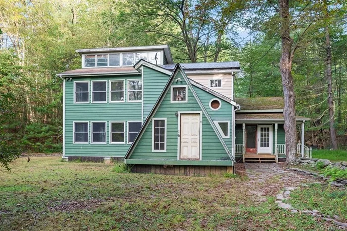 Escape to your serene woodland retreat with this unique 2 bedroom, 2 full bath contemporary home boasting 2, 034 square feet of living space. Nestled in nature, the exterior showcases a creative blend of architecture with charming A-frame accents and expansive windows that allow natural light to pour in, enhancing the tranquil forest views. Inside, you&rsquo;ll find a spacious, vintage-inspired kitchen featuring a cozy design with retro cabinetry and rustic wood accents. This home offers plenty of potential for personal touches, with ample living space spread over multiple levels. Perfect for those looking to create a peaceful hideaway.