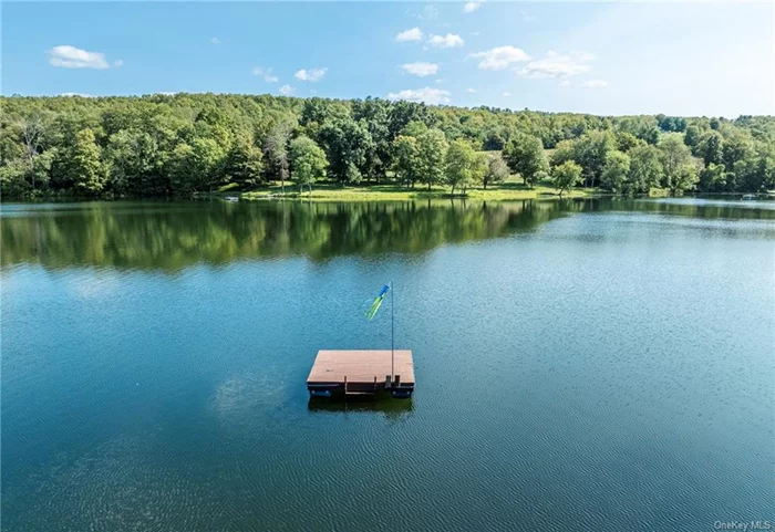 This is Hudson Valley lakefront living on gorgeous and private Upton Lake. The waterfront retreat has 43 feet of frontage on the 46 acre, spring fed, 55 foot deep glacial lake in Clinton Corners, NY. Year long tranquil and picturesque experiences await you here with an abundance of recreation, relaxation, and nature. Thoughtful decking and mature landscaping leads down to the lake, where you access it from the waterfront dock or a floating one nearby. Simply stunning. The decking includes a hot tub + outdoor shower. Entering the home you arrive in a three season, charming screened or windowed front porch. This level includes open kitchen/dining w/ sliders to lakeside decking, small office, laundry and full bath. The upper level includes wall of windowed primary bedroom with cathedral ceiling and ensuite bath. Two other bedrooms are also here. The lower level is living space/den with herringbone flooring, more glass sliders leading to the lakefront magic. A workshop and mechanicals are also on this level. Convenient to the Taconic State Parkway, this is all just 2 hours from NYC. Welcome to the Hudson Valley.