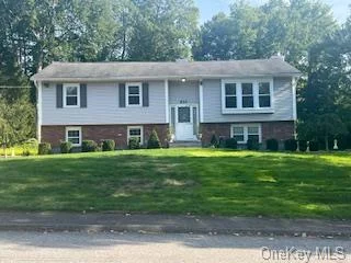 Welcome home to this beautiful raised ranch in Yorktown Heights! This home is meticulously maintained and updated. This home features 3 bedrooms, 2.5 full baths, living room, dining room, eat-in kitchen that is updated w/granite countertops and stainless steel appliances with access to a 3 season room that is great for entertaining and deck that leads to access to your beautiful backyard. The lower level has a large family room with a fireplace, den/office and laundry room. The beautiful grounds with mature plantings that provide you with privacy and will ensure countless hours of outdoor entertaining and fun. Attached 2 car garage. Hardwood floors throughout, CAC, and central vac, whole house generator and an irrigation system. Prime location with easy commute: less than 1 hour to NYC Close to Taconic State Pkwy, shopping, restaurants and schools. Lakeland School District & sewer and municipal water. A must see to appreciate.