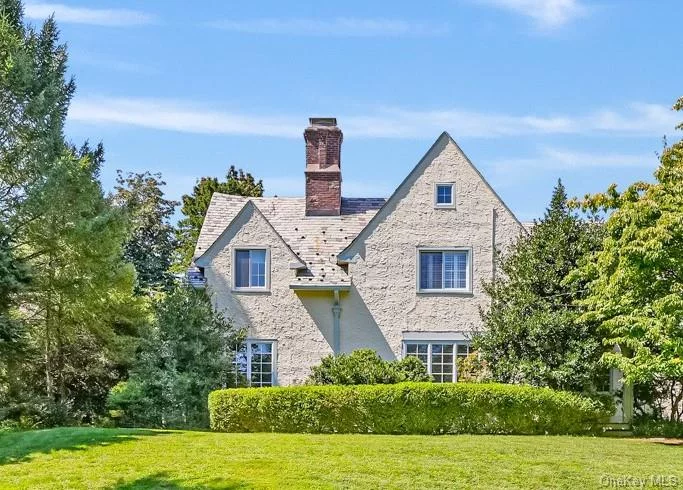 Nestled in the heart of Scarsdale&rsquo;s historic Cotswold district on a half of acre of land, this charming Tudor-style home offers a perfect blend of modern comfort and timeless elegance. Just a stone&rsquo;s throw from desirable Scarsdale village and Metro North station, convenience meets tranquility in this bright and airy abode. Step inside to discover gleaming hardwood floors and an abundance of natural light streaming through numerous windows and skylights. The inviting entry foyer leads to a formal living room, complete with a cozy fireplace perfect for those chilly evenings. Be delighted by the den or library, featuring custom-built shelves for your literary treasures. The oversized formal dining room sets the stage for memorable gatherings, while the eat-in kitchen boasts cherry cabinets that add warmth to the heart of the home. The piece de resistance? A spacious family room with vaulted ceilings and French doors that open onto a generous patio, beckoning you to enjoy the outdoors. Ascend to the second floor, where you&rsquo;ll find two sizable bedrooms and a full hall bathroom. The primary suite is a true retreat, featuring a dreamy en-suite bathroom and an additional room ideal for a nursery or home office. Need more space? The walk-up attic provides ample storage for all your seasonal decor and cherished mementos. Outside, prepare to be enchanted by your private oasis with lush plantings. Set back from the street, this home offers a serene escape. The large patio leads to a hidden treasure  a spacious in-ground pool with ample privacy and perfectly situated for everyday living and entertaining. With its proximity to top-rated Edgemont schools, and easy access to public transportation, this home truly offers the best of suburban living. Don&rsquo;t miss your chance to make this modernized Tudor your own slice of Scarsdale paradise!