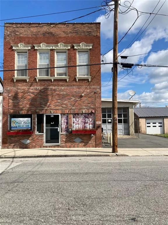 Earn 12% return on investment or a lot more. Great Historic brick building on Front Street in the Renaissance City of Port Jervis. This Huge 3500 square foot building is Active Business downstairs and two modern residential apartments upstairs. Walk to NYC Trains. Would be Great as an Air B&B which would bring the CASH in hand over fist. As is now Business pays $2200 per month and apt bring in $2700 for $4900 gross oer month of $58, 000 gross per year. Net return on Income is $48, 000 per year as tenants pay water sewer and utilities.