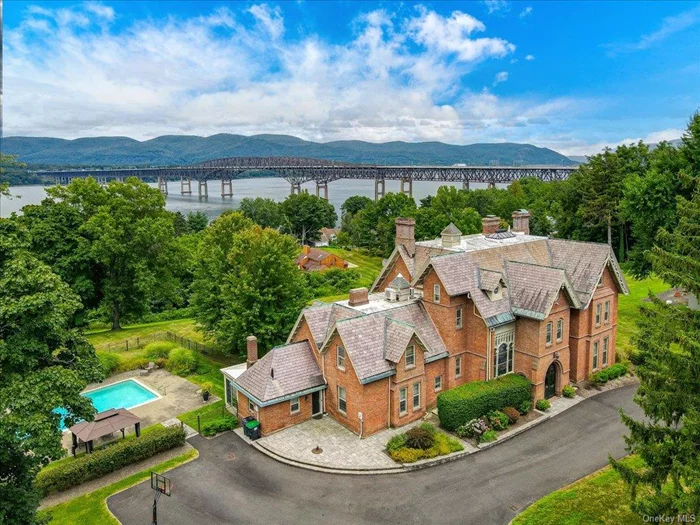 Offering a unique opportunity to own a piece of architectural history, The Rest, a High Victorian Gothic-style home that sits majestically on the western banks of the Hudson River in the Balmville hamlet of Newburgh. Built for Daniel Bennett St. John, one of the founders of The New York Times, this home was crafted by the renowned architect Frederick Clarke Withers, a leader of the American Gothic Revival movement in America and protege of Andrew Jackson Downing. Exceptional craftsmanship, amazing river views, and meticulous attention to detail throughout define this gorgeous three-level home featuring intricately carved wood moldings, soaring 11+ foot ceilings, floor to ceiling windows, and rich hardwood surfaces. It is currently being used as a five-bedroom home but could easily live as an eight-bedroom, and offers large spacious rooms, an open and seamless layout and 4.5 bathrooms. One of the most breathtaking features is the Tiffany-style stained glass window, a true masterpiece that transforms with the changing light throughout the day, casting vibrant displays of color and creating a living work of art. There were six original fireplaces, five of which had been converted to coal, but the beautiful custom carved marble mantles remain intact. The library&rsquo;s wood-burning fireplace is still functioning and features a finely carved wood mantel. There is also a skylight spanning from a cupola above to the third and second floor, providing light into both levels. The house provides ample space for extended family, an au pair, or dedicated quest quarters. The exterior is adorned with elaborate Gothic details that mirror the home&rsquo;s stunning interior. As an apprentice of Andrew Jackson Downing, and a partner of Calvert Vaux, it is apparent that Withers applied their philosophies of integrating architecture and nature when determining the position of this home, strategically complementing the picturesque Hudson River landscape and view. A stunning bluestone veranda stretches along the river-facing side of the house, offering breathtaking views and serving as an extension of the indoor living space. Other quality features include an updated chef&rsquo;s kitchen with a stunning reclaimed wide-plank wood flooring that extends into the family room, a convenient butlers pantry, updated bathrooms, screened in porch overlooking the pool area, 18&rsquo;x36&rsquo; in ground concrete pool with brand new pump, beautiful landscaping, and blacktop circular driveway. Ideally located just 64 miles from Manhattan and only 6 miles from the Beacon Metro North Train Station. Also, minutes to local restaurants, shops, hiking, walking trails, the Powelton Country Club, and major highways. See floor plan and 3D walk-through tour.