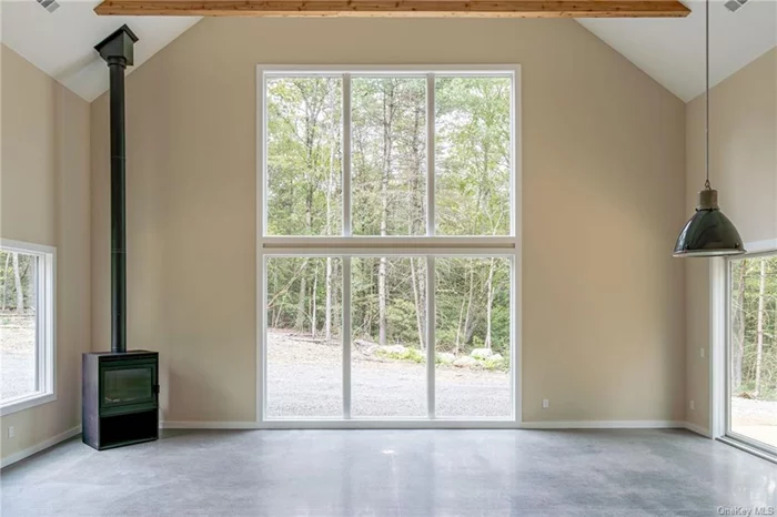 Creek Front Property. Stylish 2-story new construction by Cedar Development Group @CedarDGHomes on IG. Standing at 29-feet wide, and just under 27-feet tall, this three bedroom home is finished concrete flooring and stunning wood beams. House pictured is the identical floor plan we completed elsewhere! The statement window wall system faces directly towards the creek with an open view and approximately south / southeastern light! You can put your own final touches on this one! House has begun construction. We can show qualified buyers other finished homes by CDG. In addition to the creek frontage on your own lot, this property benefits from a walking easement over a neighboring property to get even more direct creek access!!