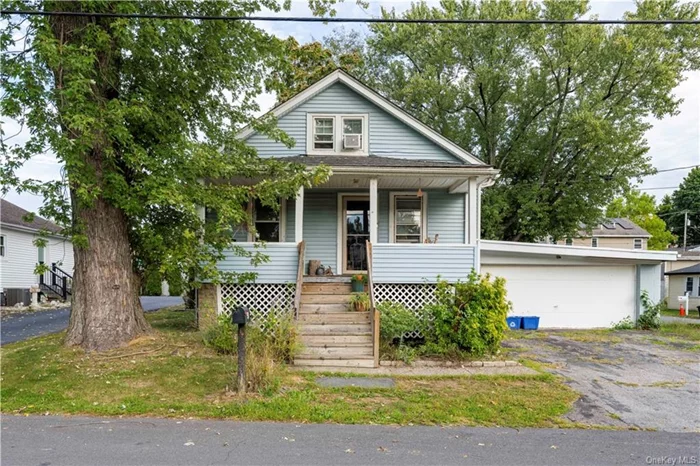 Cozy bungalow on corner lot nestled across from a serene ball field and park. What could be better? This rocking chair front porch charmer has hardwoods, nice sized living room, eat-in kitchen with pantry and access to back yard, 2 bedrooms and a full bath. The attic is heated and is partially finished. The full basement holds the washer and dryer and offers lots of storage and access to the two car garage. There is a 1/2 bath that is not functional- but it can be. The back yard is fenced in and offers lots of possibilities. This house needs some TLC but it is a diamond in the rough.