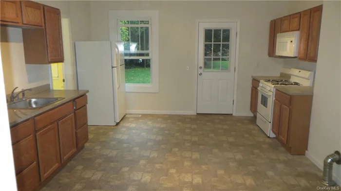 Large 2/3 bedroom apartment in the Village of Wappingers. 10&rsquo; ceiling height, built-in cabinetry, granite countertops, range, microwave and refrigerator included. Eat-in kitchen, one large bedroom, 2 small-ish bedrooms. Natural gas forced air heat. Private off street parking. Tenants pay Central Hudson Gas and Electricity. $1, 750/month. Short walk to Main Street in the Village of Wappingers.