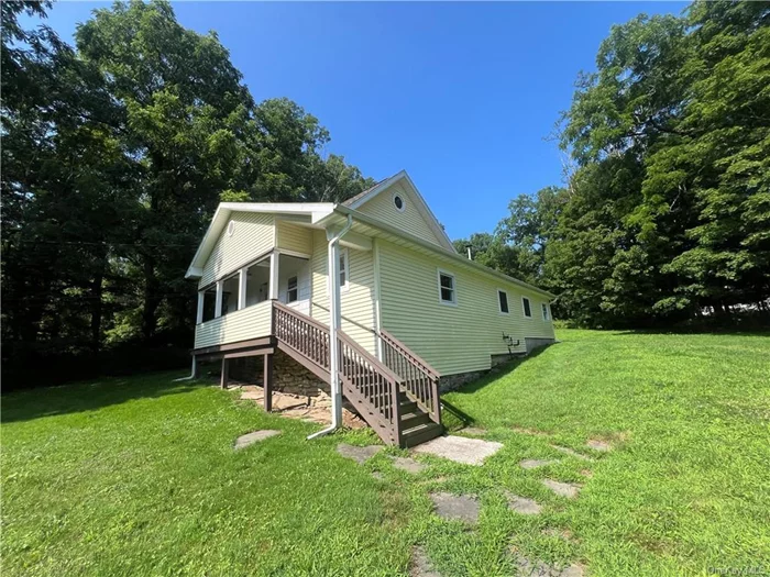 Two bedroom home with vaulted ceilings and primary bedroom suite with sliding glass door to balcony overlooking yard. Converted detached garage which was previously finished into a studio-style cottage. In-ground pool on site.  Minutes to Route 84 access and Taconic State Parkway. Offers to be presented with proof of funds or rehab loan prequalification letters. Sold as-is. Buyer to pay NYS and any local transfer taxes. **Please see agent remarks for access, showing instructions and offer presentation remarks.**