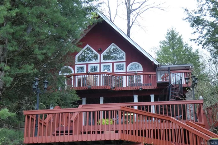 Spacious waterfront home with massive and inviting outdoor spaces, hot tub, and with access to a private dock. Indoors you will discover cathedral ceilings, multiple fireplaces, and several areas to come together. A unique find is the the detached cottage in the back that includes bunk beds, pool table, and arcade game. Swinging Bridge Reservoir is the largest largest lake in the Sullivan Catskills, and one of the few that allows motor boats. You&rsquo;ll feel removed from the city, but still within 15 minutes drive of groceries and things to do.  In addition to the listed square footage the basement and detached cabin are fully finished. Approximately 2862 sq ft total.