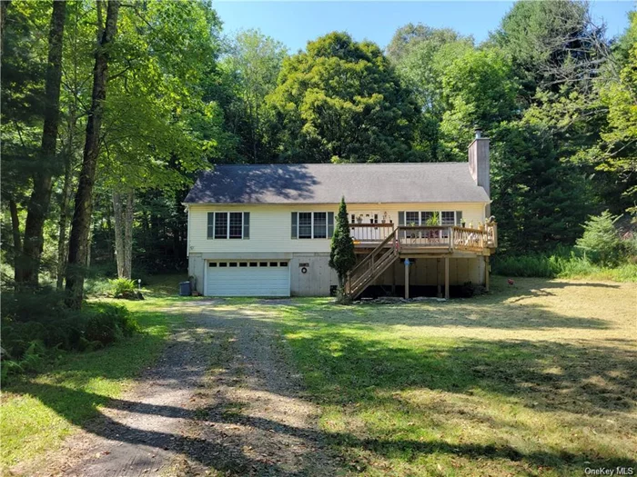 This 3-bedroom, 2-bath home offers deeded rights to the Tannery Woods lakefront beach on Swinging Bridge Reservoir, providing you with exclusive access to this 9 mile motorized lake. Nestled on 5.6 acres of park-like land, the property boasts a long driveway that ensures privacy, a charming brook, and picturesque stone walls. The home spans 2, 352 square feet and features a master bedroom, spacious rooms throughout, and both front and back decks perfect for outdoor relaxation. The partially finished basement and walk-up attic offer additional living space potential, making this home versatile. Amenities include a 2-car attached garage, a washer and dryer, and a cozy woodburning fireplace. Close to Bethel Woods (Original Woodstock Festival Site). Catskill Resorts Casino, Swinging Bridge Reservoir, shopping and restaurants.