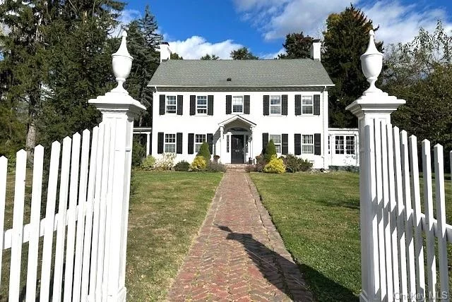 Total elegance in this perfectly maintained and updated 1925 colonial. Set way back from the road with a furnished courtyard, across from Bartlett Park. This graceful home has all its original features including a grand foyer with a dramatic winding staircase, two working fireplaces, French doors, solid wood arched doors, Pallium windows, bright and comforting glass sunroom. There are beautiful original hardwood floors in every room. The first-floor office has its own door to the outside, beautiful built-in bookcases, and a cheerful wood burning fireplace. The eat-in kitchen is spacious and bright, with stainless steel appliances and soapstone counters.  The living room is bright and airy and has its own fireplace. Don&rsquo;t miss the two bedrooms (or studio, den), a full bath on the 3rd floor, which are not counted in the total square footage. The basement is dry and has a laundry room, shop, exercise room, storage. This is an amazing find for lovers of historic homes.