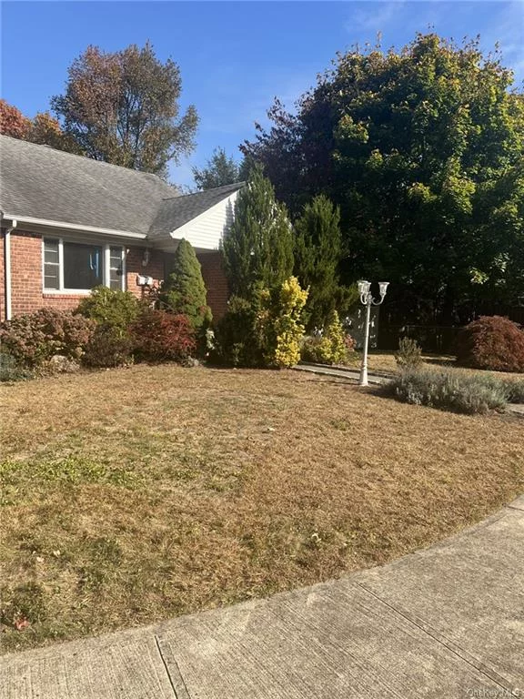 Welcome to this lovely 4-bedroom 2-bathroom center hall cape located in the desirable Poet&rsquo;s Corner neighborhood of Hartsdale. The first level boasts a beautiful living room with a large picture window and cozy fireplace, a spacious formal dining room and an updated eat-in kitchen flooded with natural light and large windows and sliders that walk-out to the custom patio and level, fenced in yard. This level also offers a 2 large bedrooms, and an updated full bathroom. The second level offers two additional bedrooms with an abundance of closets and a tastefully updated full bathroom. This property boasts many upgrades including brand new windows, the entire home has been freshly painted, beautiful refinished hardwood floors, a new floor in the basement, and a new water heater! The walk-out lower lever offers an opportunity for additional living space and ample storage. Fabulous location near public transportation, shops, schools and restaurants. This home will not last long.