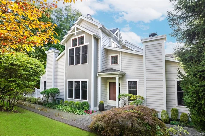 Homes like this rarely become available at The Landing, Dobbs Ferry&rsquo;s lushy landscaped premier 35-acre riverfront community along the shores of the Hudson. This rare 3500 sf sun-filled corner townhome not only features a stair-free private primary suite on the main level, but also a second primary on the upper floor, an extra-large end-unit outdoor deck, and a peaceful site that takes full advantage of the sights and sounds of Wickers Creek at its backyard border. A double-height entry with marble floor sets the scene for an open-concept plan flooded in natural light. Tall, north-facing picture windows create a focal point under the soaring ceiling of a generous living room, offering a gas fireplace and dazzling daylight from a 2nd floor balcony. Diagonally-laid oak floors throughout this level flow into an adjacent dining room enhanced with crown moldings, chair rails, and plenty of sunshine. At the south end of the home, delight in a spacious Great Room - the heart of the home. A towering family room with dramatic ceilings, built-in wood entertainment center, a bank of corner windows, and the home&rsquo;s 2nd fireplace are all open to an adjacent eat-in kitchen. Here, you can savor cooking at an expanse of marble counters, sitting at a 3-seater island, or dining at the breakfast room table awash in sunlight. Glass sliders lead to an extensive and tranquil wood deck - equipped with gas hookup for grill - to delight in meals amid the soothing sounds of the running creek and views of the dense woodlands. The home&rsquo;s main level primary suite, offering its own private set of French doors for deck access, features a tray ceiling, two walk-in closets, and a tumbled marble bath with dual vanities. Upstairs, an equally stunning primary boasts additional height with its 12-ft-tall tray ceiling. A third bedroom is roomy and bright, with two exposures and double-wide closet. As a bonus, the upper landing expands into an open office loft with striking sloped ceilings and a mosaic of large picture windows illuminating the space! Discover a vast 4th bedroom/ recreation room and the home&rsquo;s 4th bath on the walk-out lower level. Additional storage is plentiful in the sizeable attached 2-car garage. Enjoy the beauty of the Hudson while swimming in The Landing&rsquo;s private heated pool, playing tennis and pickleball, or working out in the fitness center. Relax at a secluded sandy river beach with dedicated footbridge access, or follow the Aqueduct trail to award-winning schools, a vibrant downtown, and the MetroNorth train station. Inside and out, this home is just waiting to welcome you!