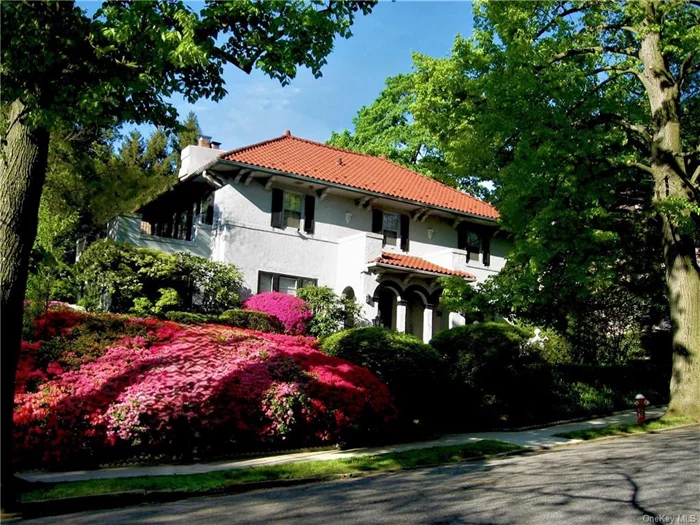 Move-in ready. This majestic renovated four-bedroom Mediterranean villa near Bronxville is set on a lushly landscaped large corner property. The arched, covered portico, massive stone walls, terraces, patios, lawn sprinkler irrigation system and fully operable in-ground gunite mini pool complete the private outdoor oasis. The flagstone walkway leads to a traditional black door with brass lion-head knocker and into the grand entry foyer featuring a sweeping curved staircase and distinctive balustrades. Formal center hall layout is perfect for entertaining and relaxing, with leaded-glass double French doors opening to the huge living room and elegant dining room, both with oversized moldings, gleaming maple floors and custom fireplace. A paneled room with three exposures, bay window and custom built-ins can be used as a home office or bedroom. Separate in-law apartment. The updated kitchen and butler&rsquo;s pantry have granite counters, a breakfast nook and mud room. Upstairs, the huge ensuite master bedroom has its own private 220 SF terrace, cedar closets, and enormous tiled bath with separate shower room. Two additional bedrooms and bath are on the second level, and there is a half bath with gold fixtures on the first floor. The lower level, with rec room, laundry, full bath and playroom, accommodates au pair or in-law living. The heated, two-plus car garage is below the house, with direct access. The 1, 500 SF attic with cathedral ceiling (not included in house area) can be finished to suit your needs. New 200-amp service and upgrades throughout. Freshly painted, inside and out. Ultra low taxes.