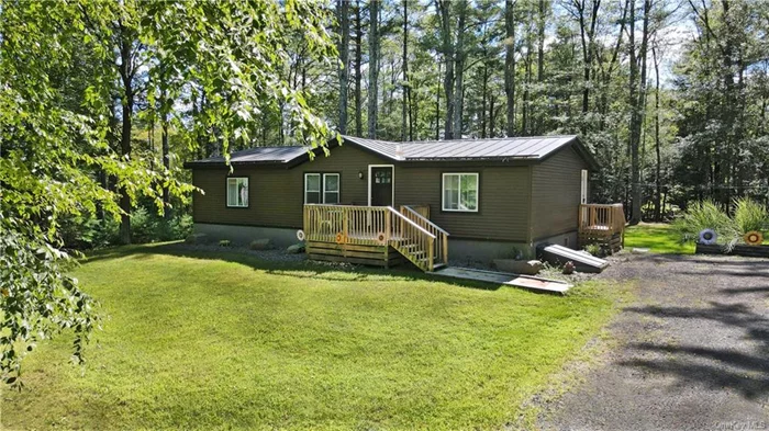 Nestled deep in the woods, this peaceful haven provides a tranquil escape from reality. A spacious driveway welcomes guests, while the inviting backyard landscape is perfect for family gatherings and cozy nights by the fire. This home showcases an open floorplan with high ceilings, two bedrooms and two baths. Just off the living room you will find the master bedroom featuring a beautiful newly renovated en suite, while the second bedroom is conveniently situated near the second restroom. The full basement has tons of storage space and is complete with a newly built third room which offers versatility as an office or guest bedroom leaving tons of basement space for the imagination. In recent years the home has had many updates inside and out, including a new kitchen, new floors throughout, a metal roof, new windows, siding, decks and some electrical upgrades. There&rsquo;s nothing left to do except move in and enjoy the peace & quite that nature has to offer. You&rsquo;re conveniently located between Woodstock and New Paltz where there are plenty of Brewery&rsquo;s to choose from along with nearby Farms for the freshest produce and tons hiking trails, creeks & more for the outdoor adventures.