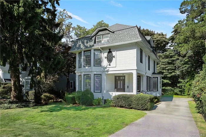 Timeless elegance blends with modern amenities in this classic Edgewood Colonial. This sun-filled home boasts large windows, hardwood floors, a charming front porch, and high ceilings throughout the first and second level. The first level features a living room with a wood-burning fireplace, an elegant family room, gracious formal dining room with beautiful architectural detail, a powder room, fabulous white eat-in-kitchen with stainless steel appliances, Quartz counters, and a mudroom leading to a private level backyard. The second floor offers four spacious bedrooms including an en-suite master bedroom with master bathroom, a hall bath and a washroom. The third floor with beamed ceilings provides a possibility for a second master bedroom with office/Zoom space/second family room, a fantastic full bath and huge WIC. The lower level has a versatile space with a Bilco door to the backyard. Conveniently located close to Scarsdale village, transportation, schools, shopping and parks.