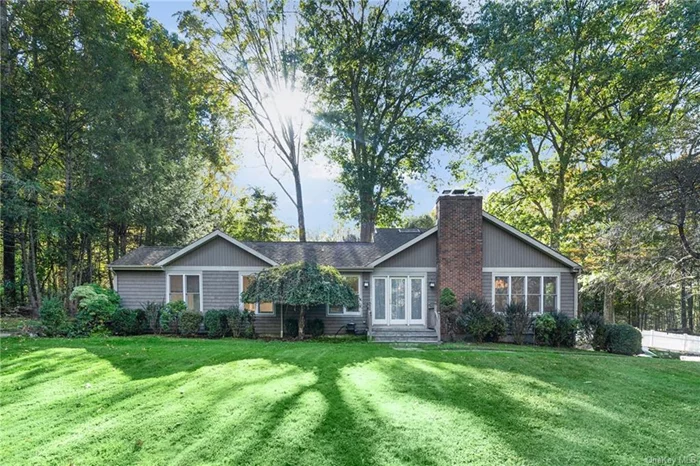 Situated at the top of an enclosed neighborhood, this Ranch home offers privacy, space and upgrades. Beyond the stone wall is this spacious and sun-filled home. The foyer leads to the open floor plan living space featuring an oversized living room with vaulted ceiling, sky lights, hardwood floors and 2 sets of sliding glass doors to the large deck. The living room is open to the eat-in-kitchen appointed with granite counters and stainless-steel appliances. Entertain in the formal dining room with custom molding and fireplace. 1st floor powder room. Enjoy a 1st floor primary bedroom offering a large walk-in-closet and ensuite bathroom. 2nd floor offers 2 bedrooms and hall bathroom. Cool off in the pool or enjoy the private 1.3 acres. Additional space for guests, au-pair or entertaining can be found in the pool house with breakfast bar and full bathroom. Oversized garage. Upgrades include a hardwired whole house generator, electric car charging station and electric fence for pets