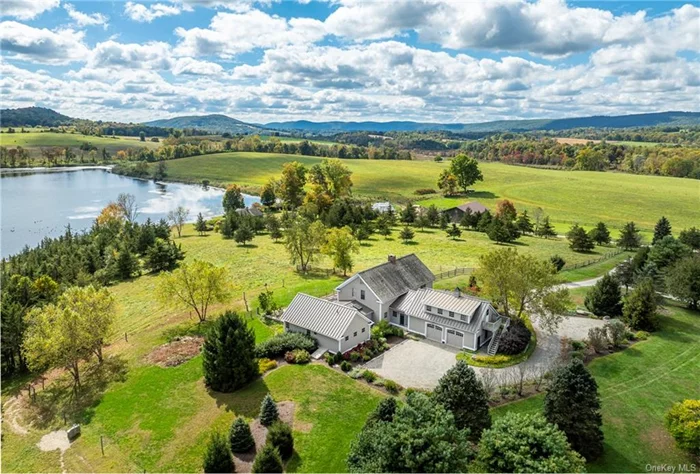 Peaceful and serene, this country compound offers sweeping bucolic vistas and frontage on the picturesque Round Pond. A long driveway leads to the pristinely landscaped 4, 498 square foot post and beam main house with three bedrooms and four baths. The spacious beamed great room has soaring 24&rsquo; cathedral ceilings, a fireplace and views from every window. Adjacent is a new top of the line kitchen with Thermador appliances. For al fresco dining, through the French doors, is a pergola with awning, an outdoor kitchen with a wood pellet smoker, Wolf gas grill, burner, and sink. Included are two cold frames for garden to table meals year round, plus there are raspberries, blackberries and rhubarb. The first floor primary suite opens to the gardens and features a vaulted ceiling, beautiful milled cherry floors, two walk-in closets and an ensuite bath with marble floor. A laundry room, office, den, foyer and full bath are also included on the first floor. Upstairs, there is a loft and ensuite bedroom with a walk-in cedar closet. A separate staircase leads to an ensuite bedroom above the attached two car garage. Nearby is a dismantled c.1750 barn from New Hampshire with 32&rsquo; ceiling with three bays perfect for a collection or machinery, plus a finished two story great room, bedroom, bath, and a kitchenette. Overlooking the pond is a one bedroom cottage that has wide board floors throughout and an expansive Trex deck that wraps around on three sides with stunning views of Round Pond. Located on 23.78 acres, including a cow barn and 750&rsquo;+ frontage on Round Pond, this property is the perfect country retreat. Conveniently located near Metro North and and Sharon, CT, and just 2 hours to Manhattan.