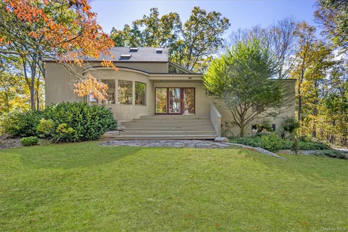 Set on 2 acres of serene, natural landscape, this sun-filled Pound Ridge contemporary perfectly combines modern architecture with peaceful seclusion. With 4 bedrooms and 2 1/2 baths, it lives like a 5-bedroom, featuring a main-level primary suite with a Juliet balcony, en-suite bath, and a cozy private den with built-in bookcases for added charm. Step into the grand foyer, which opens to a striking living room with a vaulted wood ceiling, a dramatic stone fireplace, and a wall of windows that invite the outdoors in. The open-concept family room and eat-in kitchen, complete with custom cabinetry, granite countertops, and stainless-steel appliances, lead to a multi-level deck and private, wooded grounds. A formal dining room, highlighted by a curved wall of windows, along with a powder room and laundry room, complete the main level. Upstairs, you&rsquo;ll find 3 spacious bedrooms, a full bath, and a flexible bonus room that can serve as an office, playroom, or additional guest space. The lower level boasts a bright family/game room with floor-to-ceiling windows and glass doors leading out to a second patio, ideal for outdoor relaxation. Whether you&rsquo;re seeking a spacious home for growing needs, looking to downsize in comfort, or desiring a private retreat for weekend getaways, this home delivers. Located in the scenic town of Pound Ridge, you&rsquo;ll enjoy easy access to shops, restaurants, nature preserves, walking trails, the town park, library, and a renowned golf course. Plus, it&rsquo;s just a short drive to major highways and Metro-North, making it the perfect blend of convenience and tranquility. Welcome home!