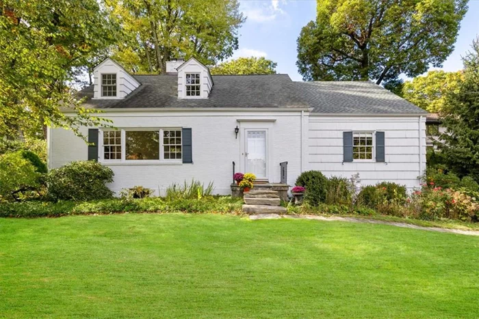 Perched atop a hill in the sought-after Edgemont school district, this charming Cape Cod home is bathed in natural light, surrounded by lush greenery, and offers stunning views. Situated on nearly half an acre, this private oasis features a spacious patio & water feature and is conveniently located within walking distance of Edgemont Jr/Sr High School, downtown Hartsdaleâ€™s eclectic dining scene, and the Metro-North station for a quick 35-minute commute to NYC.Inside, the home welcomes you with an open living room featuring a wood-burning fireplace and expansive picture windows. Hardwood floors extend throughout, complementing the homeâ€™s five bedroomsâ€”two on the first floor and three on the second floorâ€”each level offering a full bathroom. The first floor also boasts a formal dining room and a spacious eat-in kitchen with charming English cottage aesthetics, granite countertops & center island, and French doors that lead to the generously sized patio.Turnkey and lovingly maintained, this home is a perfect blend of comfort, style, and convenience.Additional Information: Heating Fuel:Oil Above Ground