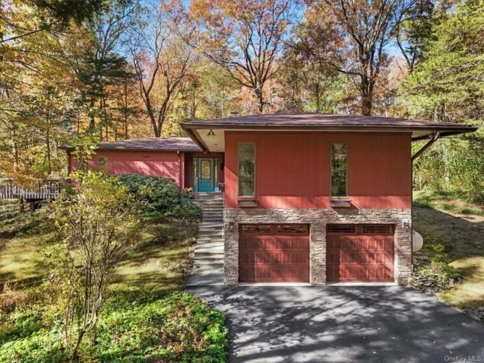 Mid-Century Modern home located on a private road in Wappingers Falls is designed by architect David Henken, an apprentice of Frank Lloyd Wright. Henken&rsquo;s work in the Usonia community is well-documented and highly sought after for its clean lines and seamless indoor-outdoor living. Tucked away on a road with only 6 homes, nestled on a 2.09 acre lot, creating a secluded oasis while still being conveniently located near Rt. 9, schools, shops, train station and restaurants. This stunning, one level home was built in 1956 atop rock using natural materials such as wood and stone. As you enter this home you will notice the floor to ceiling bank of windows in the living room/dining area which create a natural harmony between the interior and outside, in true character for a Mid-Century Modern home. The wood burning fireplace surrounded by ledge stone and warm mahogany woodwork enhance the home&rsquo;s appeal. The updated, spacious eat-in kitchen which has a glass door leading out to the deck boasts granite countertops, SS appliances, subway tile backsplash, complete with a section of tile honoring Chagall, plenty of cabinets, desk area, recessed lights. The media room has been insulated for sound. The first of 3 bedrooms is currently being used as a library/office. A hallway with full bath and laundry room leads to 2 additional bedrooms, one of which is the primary suite which features lots of windows, hardwood floors, cedar lined closet using wood from the trees on the property. The primary bath has a Jacuzzi tub, walk-in shower, block glass, water closet. Enter the large 2 car garage from the outside, walk to the back to find the mechanicals and space for a wine cellar. If you are a design enthusiast or simply appreciate the aesthetics of a well built living space, this architectural Mid-Century Modern gem may just be your style!