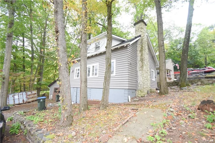 Delightful! A log home in Greenwood Lake boasting water rights! Featuring 4 bedrooms, 2 baths, a fireplace, a new kitchen, fresh paint, updated bathrooms, and much more. This spacious property includes a detached garage. Bring your boat the marina is just a short walk away, as are restaurants and more. It&rsquo;s a unique lifestyle the way of summer living!