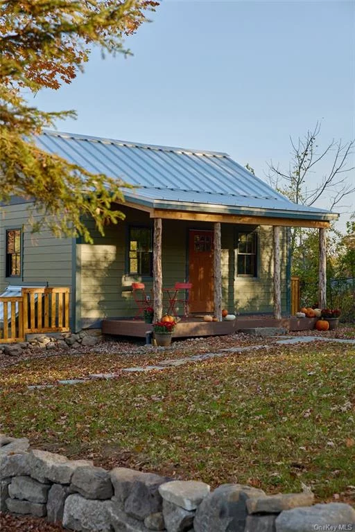 Step into Hudson Valley history with this enchanting 1890s cottage featuring rare vertical plank construction thoughtfully reimagined for modern living. The sun-filled upper level showcases an airy open plan with sleek leathered granite counters and warm red oak floors. Downstairs, find two cozy bedrooms with polished concrete floors, a convenient laundry closet, and clever under-stairs storage. Modern comforts like eco-friendly heating blend seamlessly with original details, while the fenced yard and garage provide space to garden and play. Within walking distance to coffee shops, dining, shopping, and the O & W Rail Trail, this 836 sq ft home offers the perfect balance of quiet living and local amenities. Enjoy easy access to the Shawangunk Ridge&rsquo;s world-class hiking and rock climbing, plus beloved local spots like Arrowood Brewery and Harana Market. Whether seeking a weekend retreat or year-round sanctuary, this lovingly restored cottage makes an ideal Catskill Region basecamp.