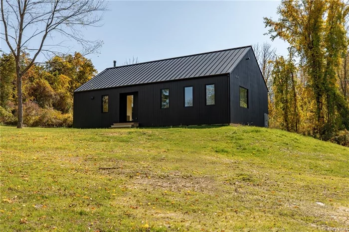 Introducing Den Outdoors&rsquo; charming two bedroom, two bath Scandinavian farmhouse in the coveted town of Rhinebeck. This thoughtfully planned single floor design consists of 1300 square feet, with vaulted ceilings in the great room and office space. The wooded park like scenery and streaming Hudson Valley light is brought into each room with large custom built windows and doors. This passive built home with south facing windows and geothermal heating and cooling will keep you at the perfect temperature all year around. Take off the chill on the wintery days with a centrally located wood stove, and enjoy the magic of the seasons from every room. Come feel the warmth of and coziness of this Den designed home, minutes to downtown Rhinebeck and 15 minutes to the Rhinecliff train station.